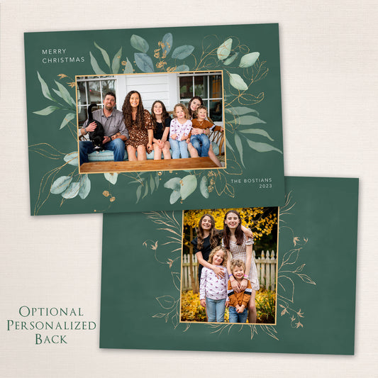 Green botanical Christmas card with gold-foil leaf design and family photo centered in a rectangular frame.