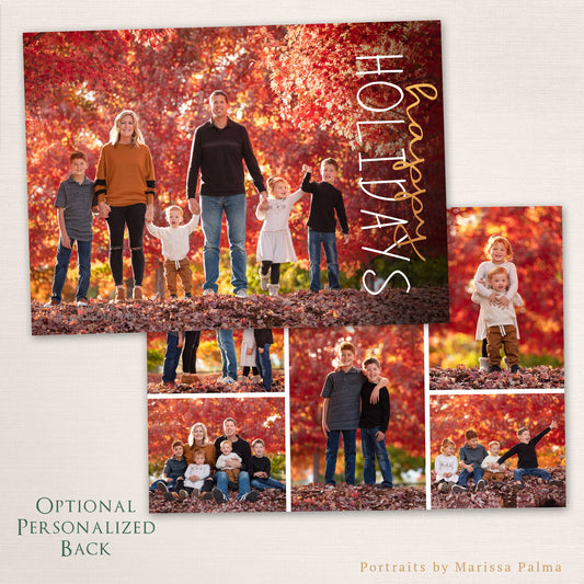 Family of six standing together among red autumn leaves with “Happy Holidays” written vertically in gold and white script, shown with an optional personalized back featuring a collage of outdoor family photos.