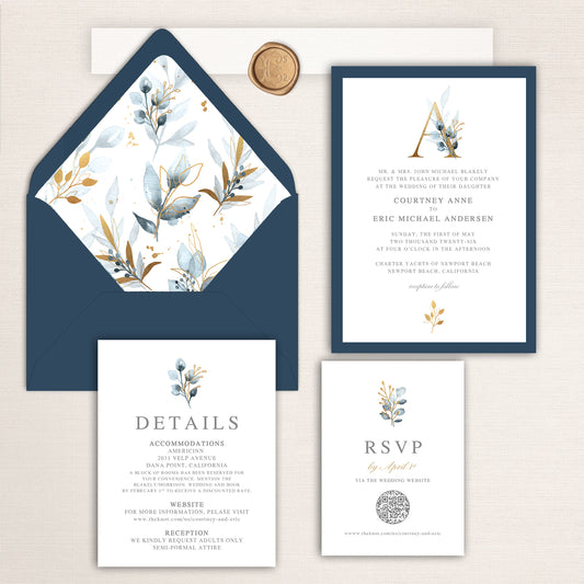 Navy and gold wedding invitation suite featuring watercolor leaves and berries, coordinated details and RSVP cards, and navy envelope with floral liner and wax seal accent.