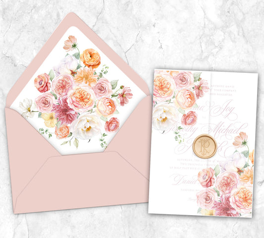 A vellum wrap for a 5x7 invitation that features shades of peach, pink, orange and dusty rose colored assortments of ranunculus, roses, dahlias, peonies, and poppies and a matching envelope liner and Cipria colored envelope.