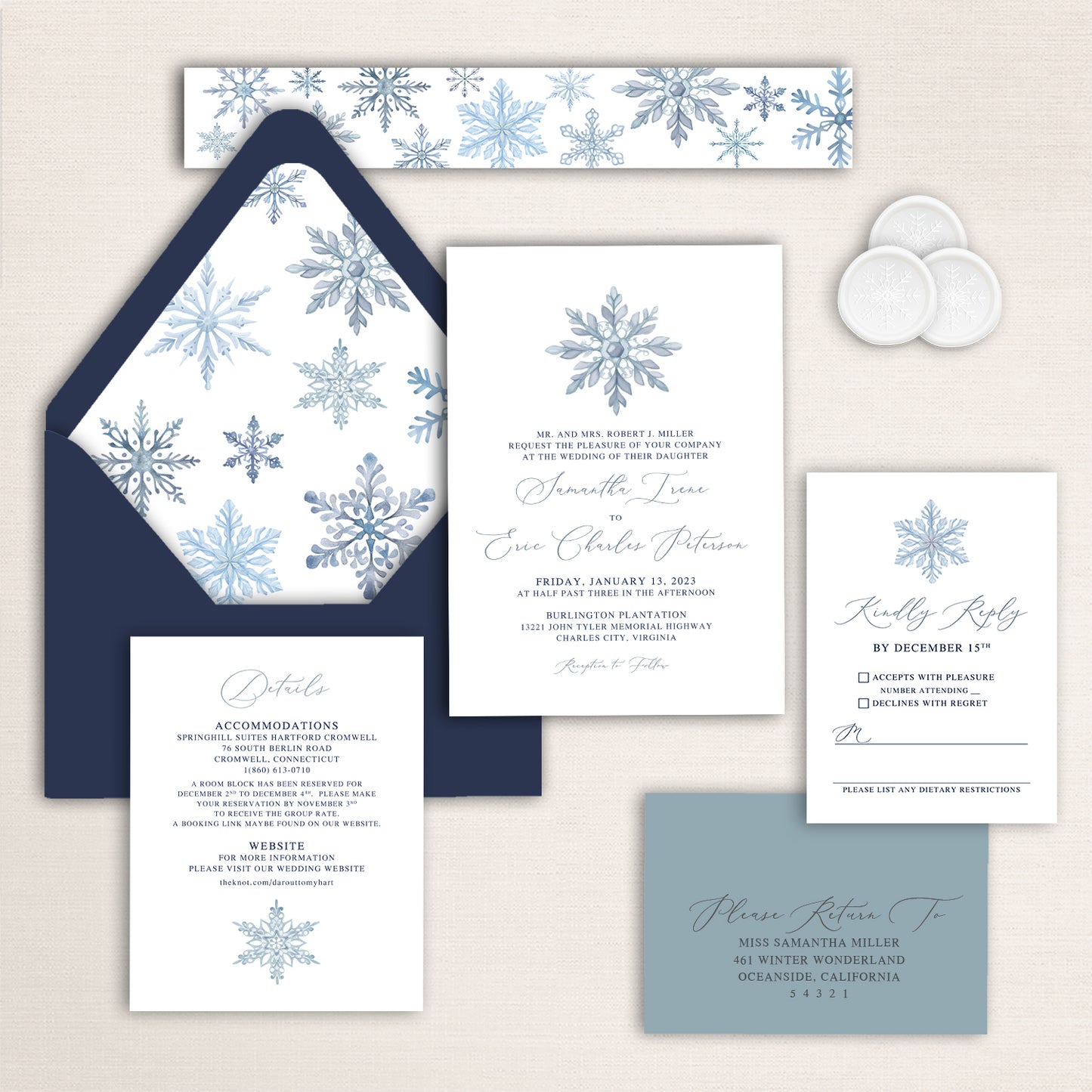 Winter wedding invitation suite with blue snowflake artwork, matching envelope liner, and coordinating stationery pieces