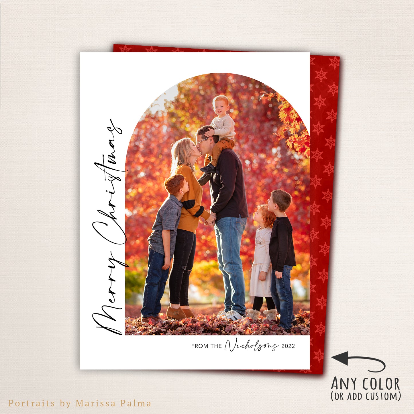 “Merry Christmas” photo card from Halo Design Shop featuring a modern arched photo layout with vertical script text, personalized family name, and a festive red snowflake-patterned back. Fully customizable colors and fonts make this elegant holiday card perfect for sharing family memories.