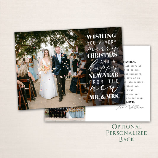 Bride and groom walking down the aisle surrounded by guests, with “Wishing You a Very Merry Christmas and a Happy New Year from the New Mr. & Mrs.” in white modern script overlay and a life update with additional photos on the back.
