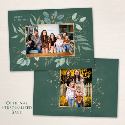 Green botanical Christmas card with gold-foil leaf design and family photo centered in a rectangular frame.