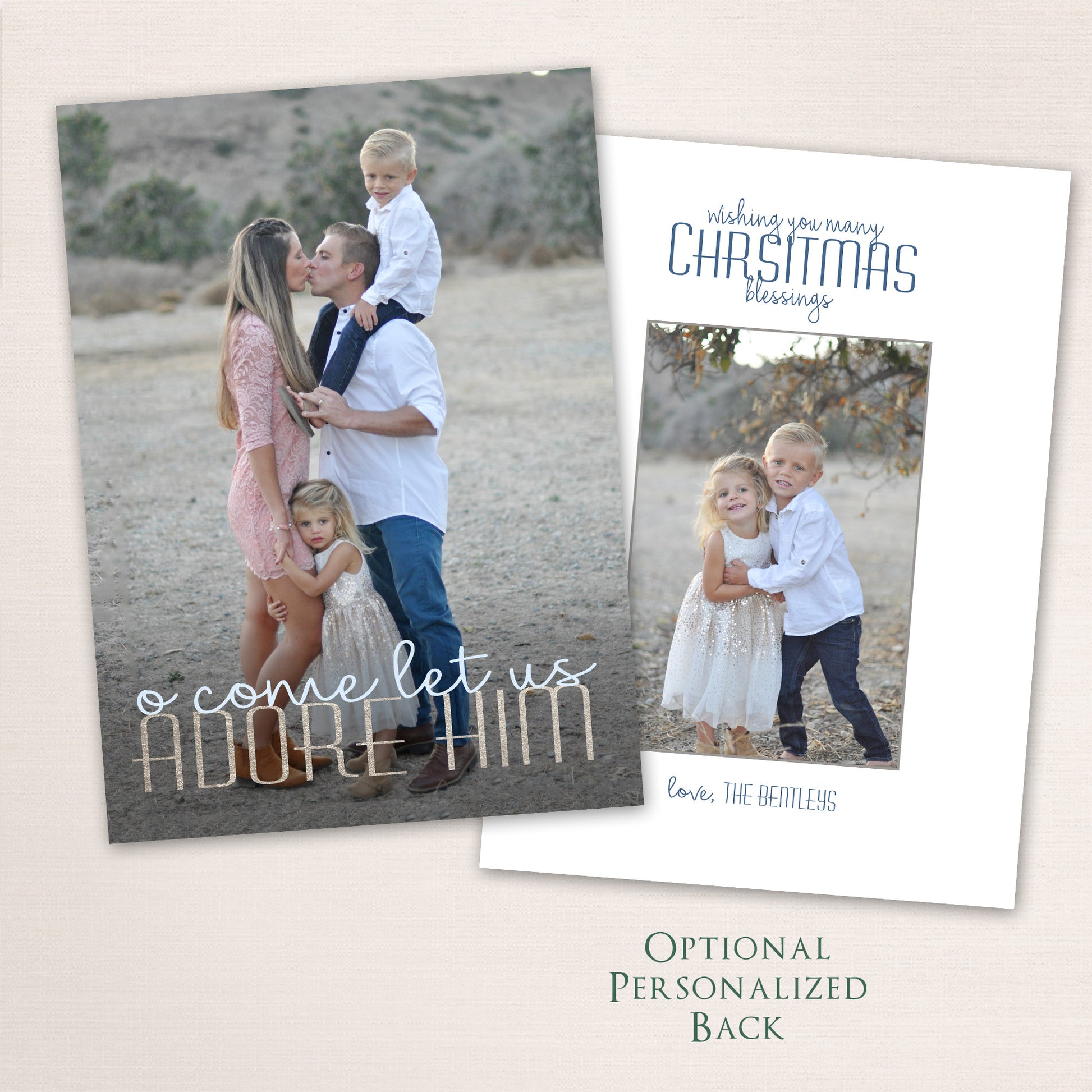 Faith-inspired Christmas photo card featuring a family of four in a natural outdoor setting. The design includes the words “O Come Let Us Adore Him” in elegant mixed script and block lettering, with an optional personalized back for extra photos or text.