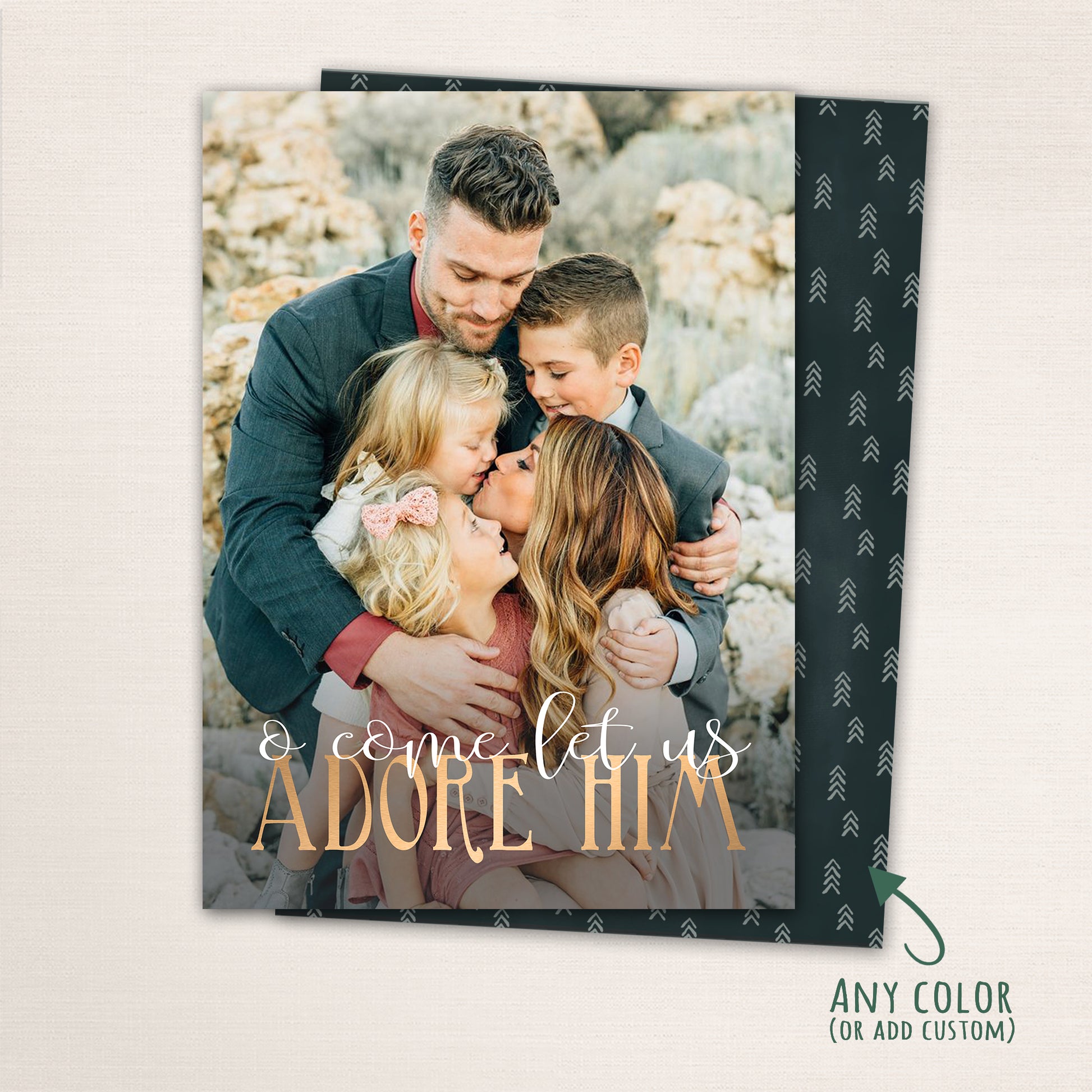 Religious Christmas photo card with “O Come Let Us Adore Him” in gold lettering over a full-family photo, featuring a dark patterned back with customizable color options.