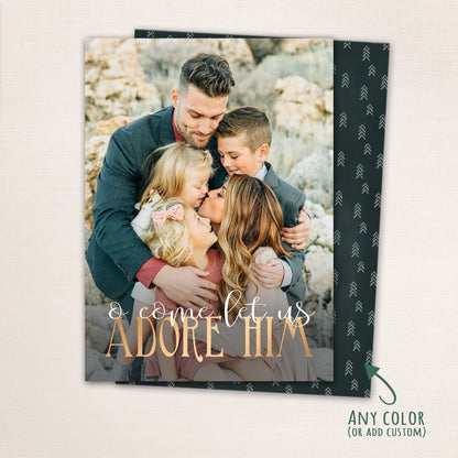 Religious Christmas photo card with “O Come Let Us Adore Him” in gold lettering over a full-family photo, featuring a dark patterned back with customizable color options.