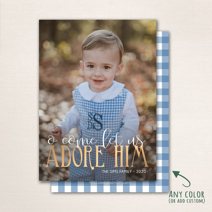 Religious Christmas photo card with “O Come Let Us Adore Him” in gold lettering over a full photo, featuring a plaid back with customizable color options.
