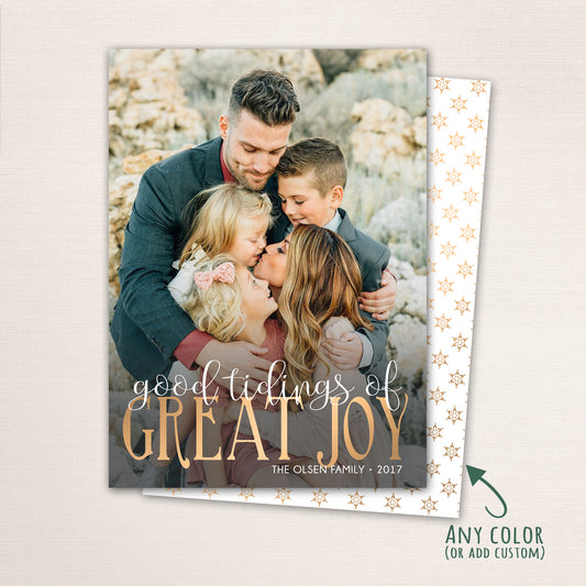 Religious Christmas photo card with “Good Tidings of GREAT JOY” in gold lettering over a full-family photo, featuring a dark patterned back with customizable color options.