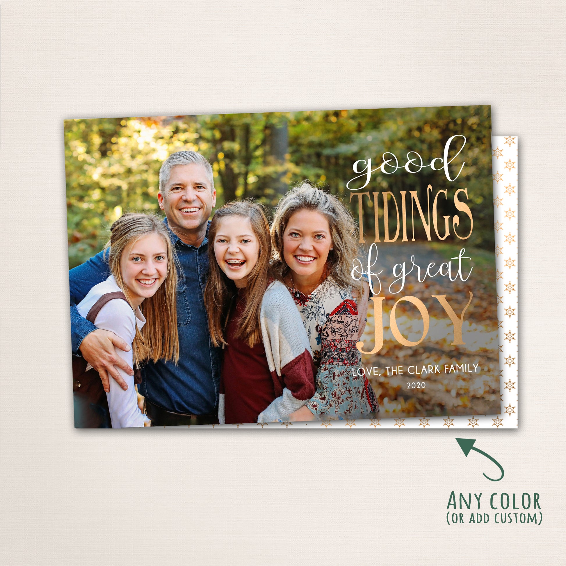 Horizontal Christmas photo card with “Good Tidings of GREAT JOY” in gold lettering over a full-family photo, featuring a dark patterned back with customizable color options