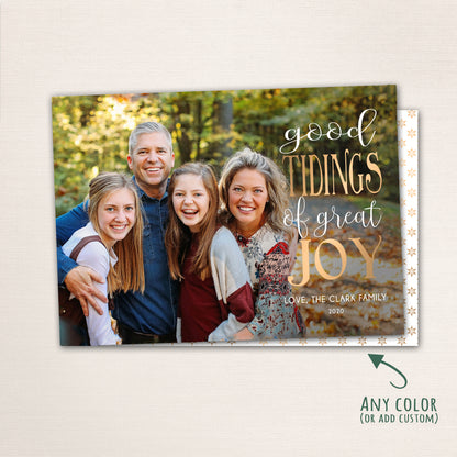 Horizontal Christmas photo card with “Good Tidings of GREAT JOY” in gold lettering over a full-family photo, featuring a dark patterned back with customizable color options