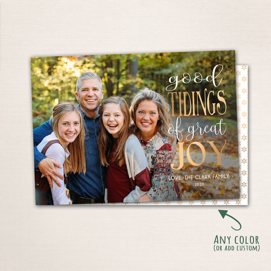 Horizontal Christmas photo card with “Good Tidings of GREAT JOY” in gold lettering over a full-family photo, featuring a dark patterned back with customizable color options