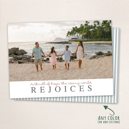 Family walking on the beach Christmas card with “A thrill of hope, the weary world Rejoices” holiday message and striped back design.