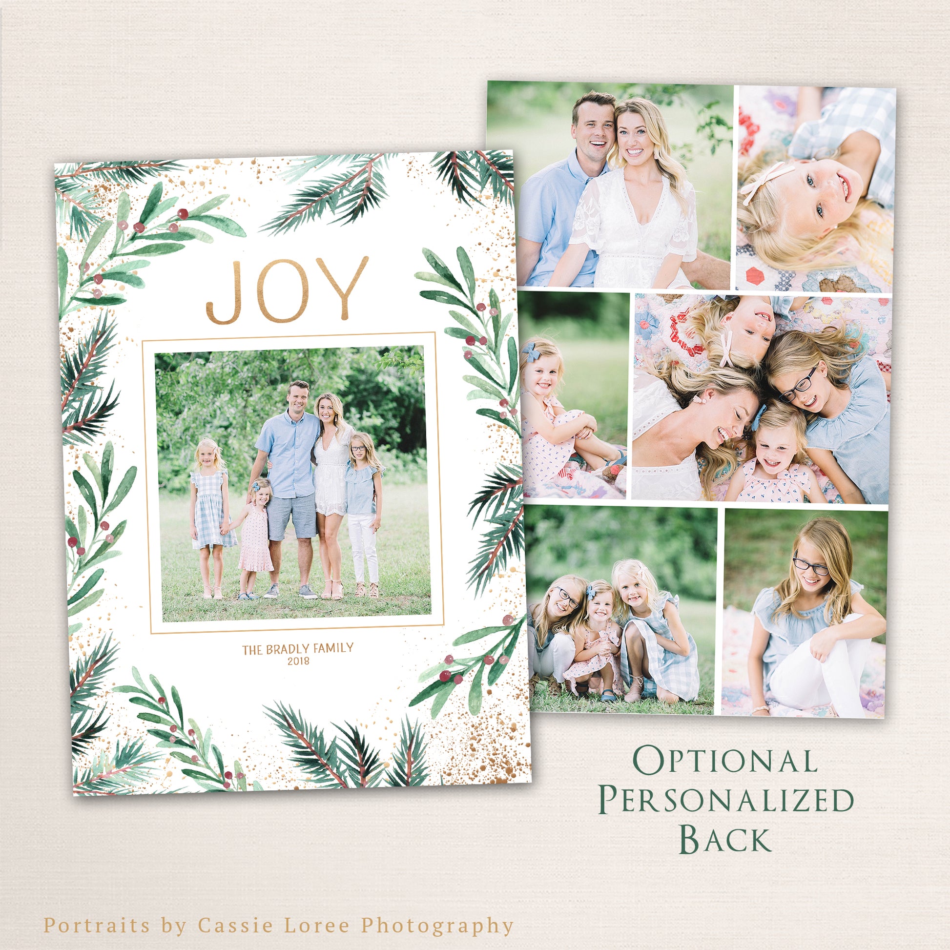 Elegant watercolor greenery Christmas photo card with “JOY” in gold text, pine and berry botanical border, and optional personalized photo collage back.