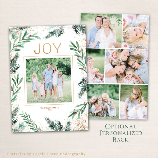 Elegant watercolor greenery Christmas photo card with “JOY” in gold text, pine and berry botanical border, and optional personalized photo collage back.