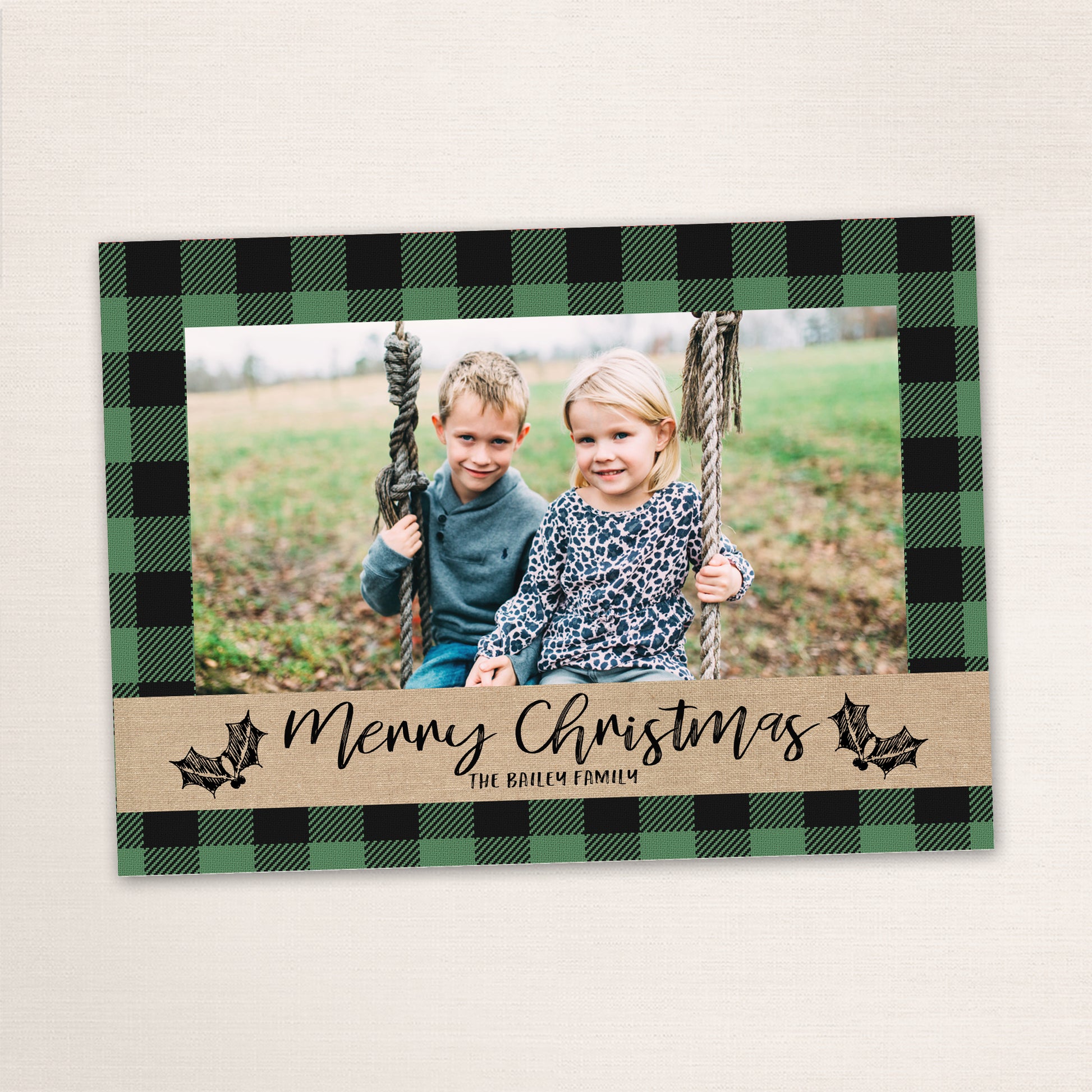 Green buffalo plaid holiday card featuring a family photo with rustic lettering and customizable plaid color options.