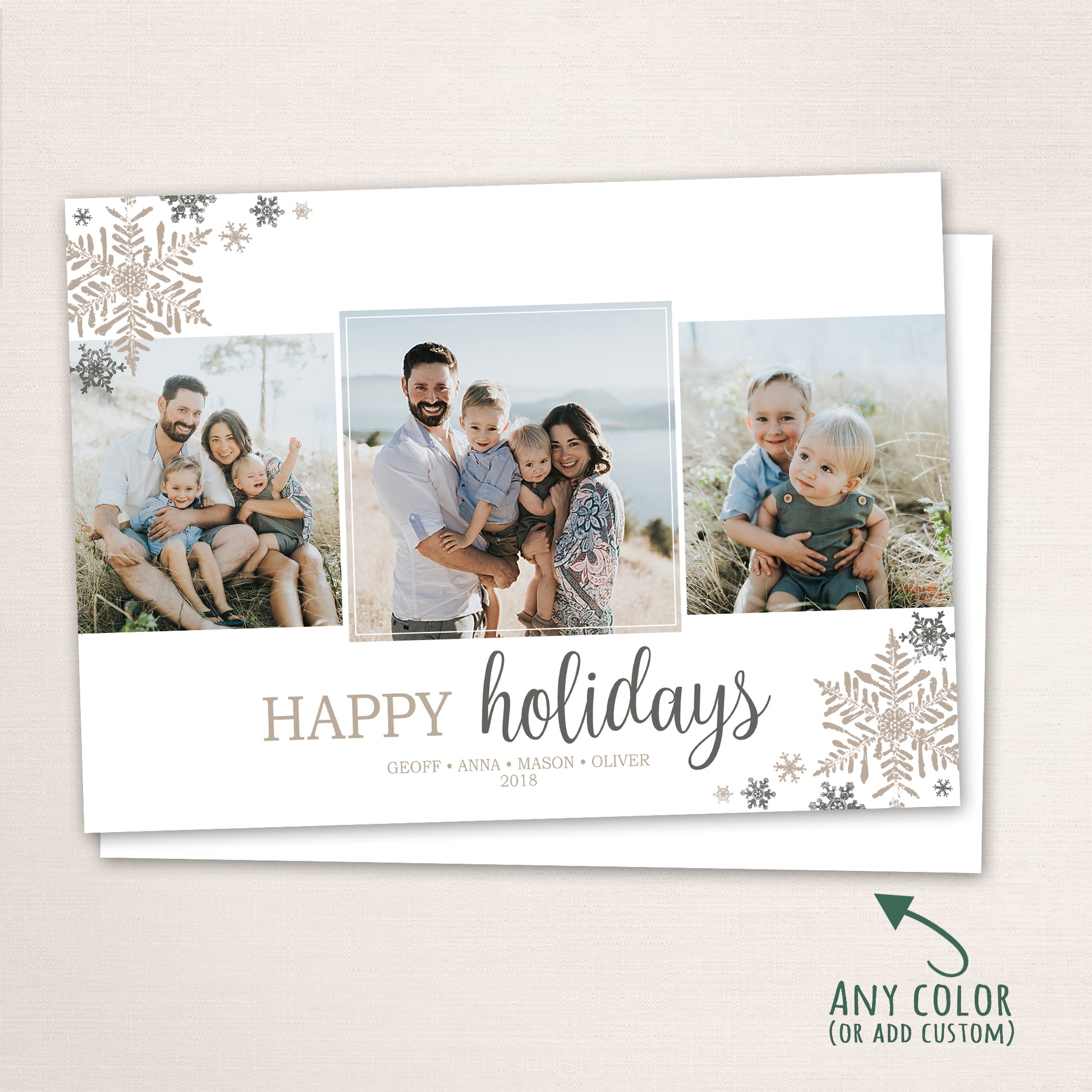 Horizontal holiday photo card displaying three family portraits with “Happy Holidays” in modern script and snowflake embellishments in soft silver and champagne tones, with a note indicating color customization available.
