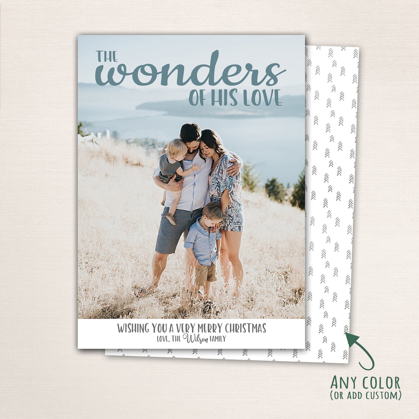 Christian family Christmas card featuring “The Wonders of His Love” text over a light, coastal background with family photo, minimalist design, and optional patterned back customizable in any color.