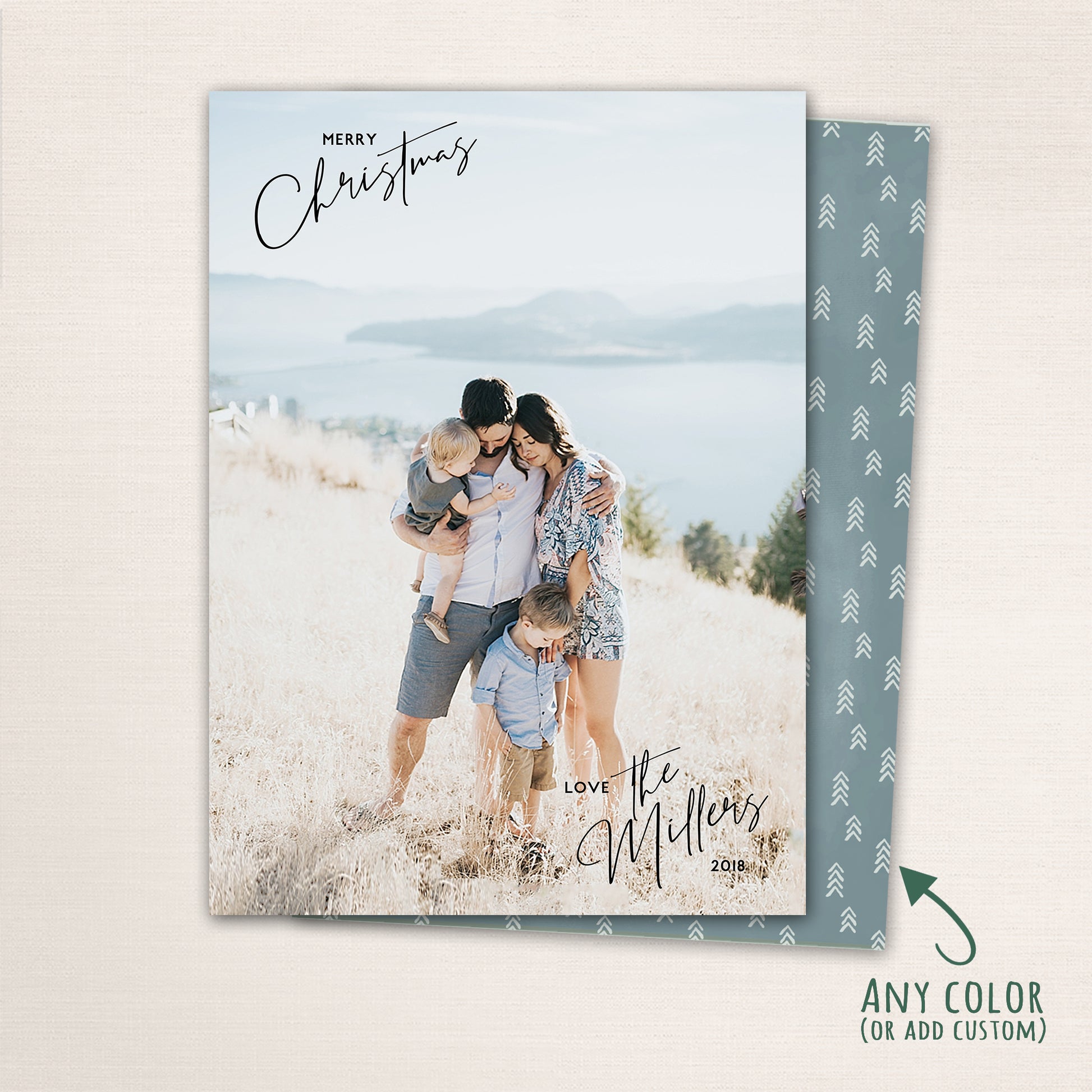 Minimalist holiday photo card with personalized family name and modern script “Merry Christmas” overlay and a mini tree pattern on the back.