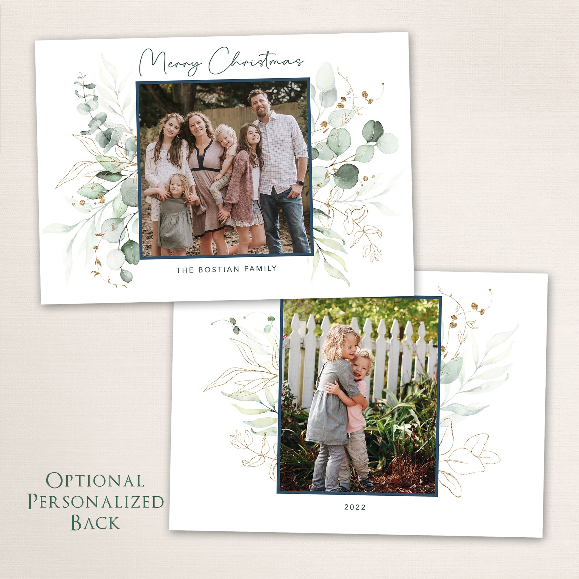 Elegant Merry Christmas photo card featuring a family portrait surrounded by hand-painted watercolor eucalyptus and gold accents. The optional personalized back showcases a second photo framed by matching greenery and soft botanical illustrations.