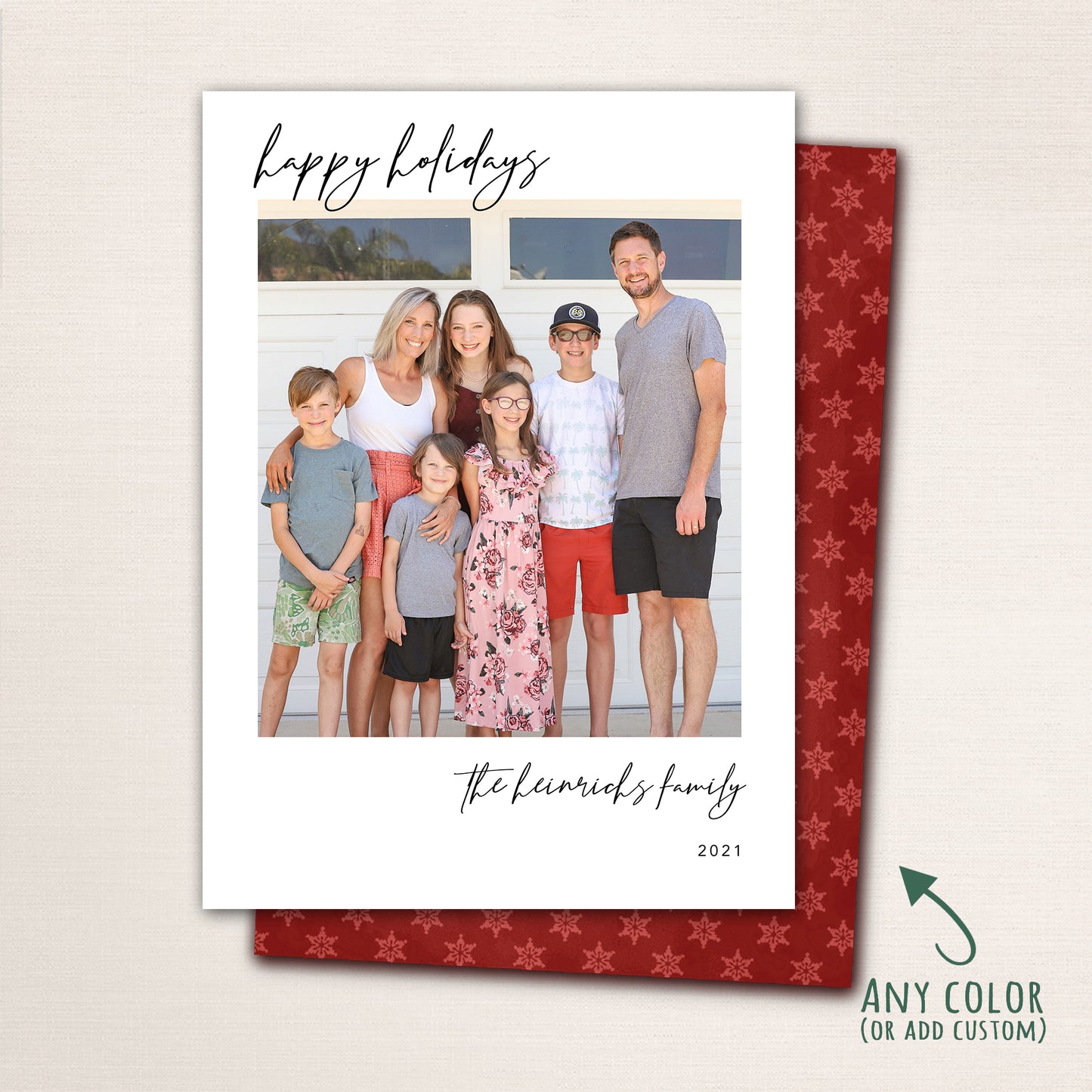 Modern Happy Holidays photo card from Halo Design Shop featuring a full-family photo on the front with minimalist black script typography and a snowflake pattern on the back.