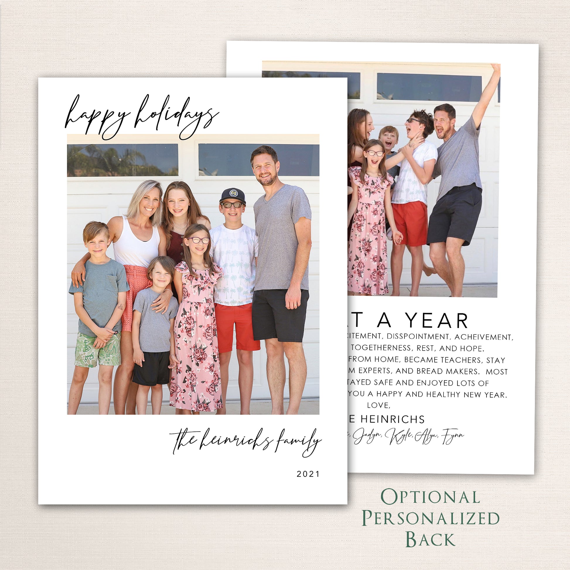 Modern Happy Holidays photo card from Halo Design Shop featuring a full-family photo on the front with minimalist black script typography and an optional personalized back for extra images or a written family update.