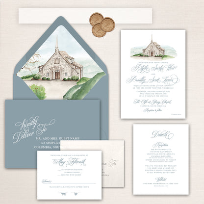 Wedding invitation suite with watercolor illustration of the Cliffs at Glassy Chapel, mountain view envelope liner, and coordinating stationery.