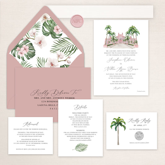 Wedding invitation suite with watercolor illustration of the Don CeSar Hotel, tropical floral envelope liner, palm tree RSVP card, and matching details card.