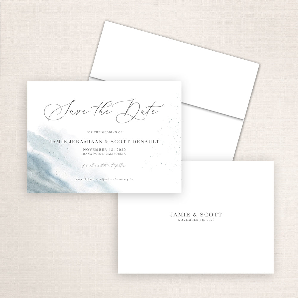 Elegant dusty blue watercolor save the date card with flowing calligraphy reading “Save the Date” and wedding details. The design includes a soft watercolor wash on the left and minimalist text on white background.