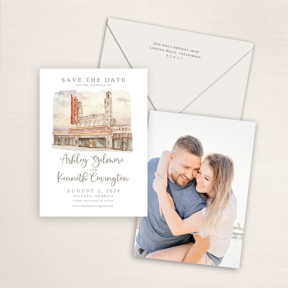 Fox Theatre Atlanta save the date featuring a hand-painted watercolor illustration of the historic marquee and facade, elegant script names, neutral envelope, and engagement photo on the back.