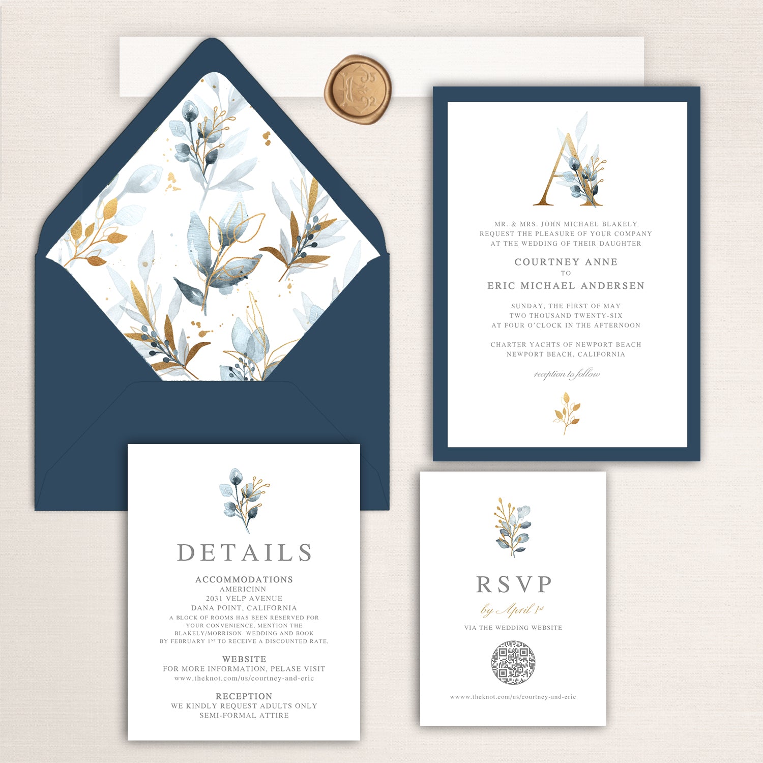 Navy and gold wedding invitation suite featuring watercolor leaves and berries, coordinated details and RSVP cards, and navy envelope with floral liner and wax seal accent.