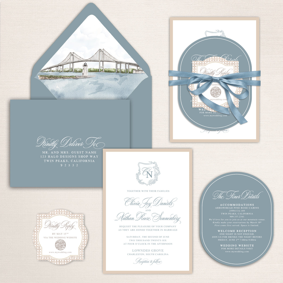 Dusty blue coastal wedding invitation suite with custom watercolor bridge envelope liner, elegant calligraphy, oval details card, decorative QR code RSVP card, ribbon-wrapped invitation bundle, and soft ivory accents for a refined waterfront wedding.