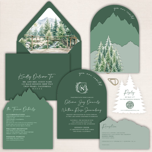Forest green and sage mountain wedding invitation suite with laser cut mountain shapes, pine tree details, arched wedding invitation, watercolor venue envelope liner, details card, reception card, and tree shaped QR code RSVP card. Elegant woodland wedding stationery designed for a rustic mountain, forest, lodge, or outdoor wedding.