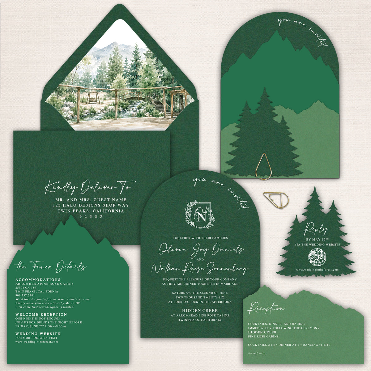 Dark forest green mountain wedding invitations featuring layered laser cut mountain silhouettes, evergreen pine trees, arched invitation cards, watercolor mountain venue envelope liner, coordinating details and reception cards, and a pine tree QR code RSVP. Nature inspired wedding stationery for an elegant mountain or woodland celebration.