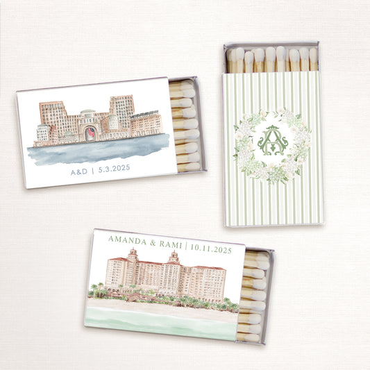 Custom wedding matchboxes featuring watercolor venue illustrations, a floral monogram wreath, and personalized text with names and wedding dates.