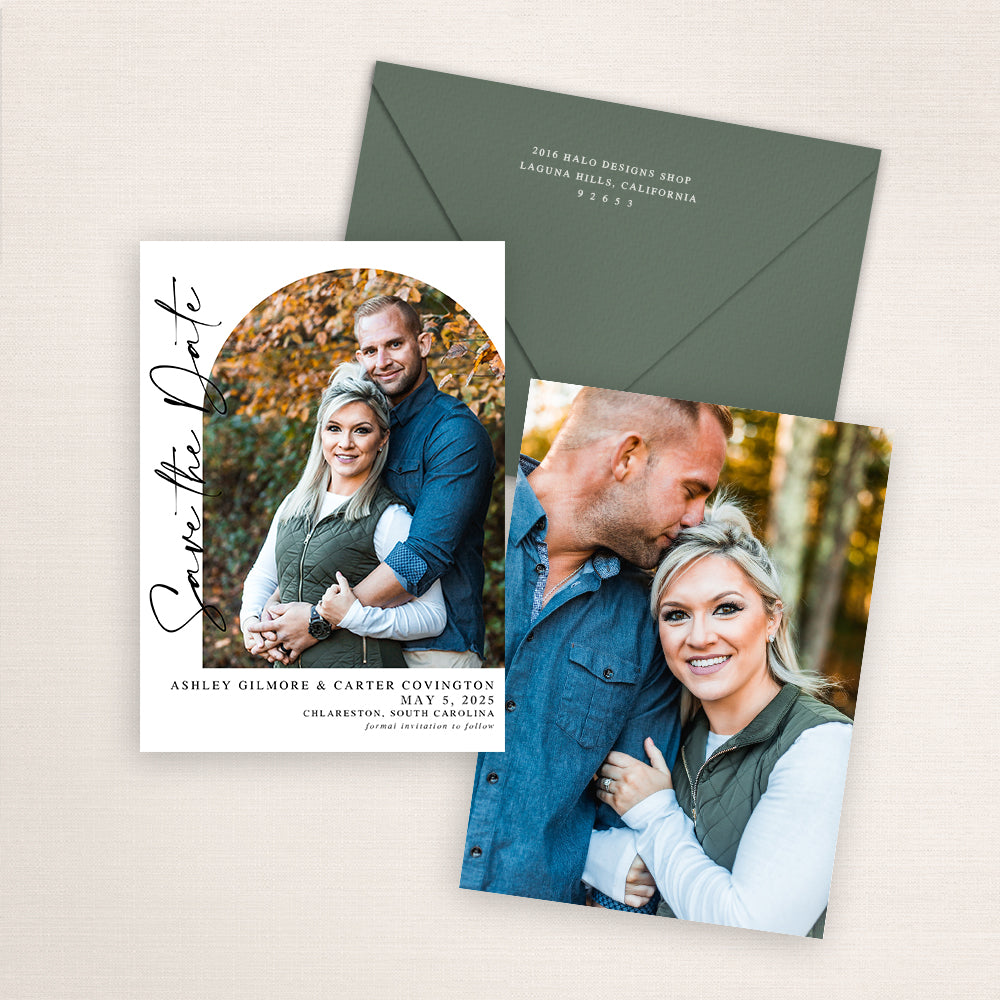 Modern photo save the date card featuring a vertical layout with an arched photo of a couple surrounded by autumn leaves. Elegant black script reads “Save the Date” along the side, with wedding details printed below. The matching back design includes their names and wedding date in minimalist black script and a matching green envelope