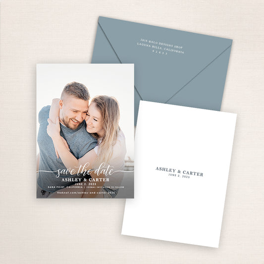 Elegant modern photo save the date suite with white script typography, matching blue envelope, and minimalist back design showing couple names and wedding date in soft gray text.