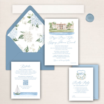 Watercolor wedding invitation suite inspired by the Powel Crosley Estate, featuring a hand-painted venue illustration, blue and white hydrangea envelope liner, monogram crest RSVP card, and coastal details with matching blue envelopes.