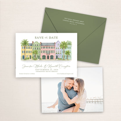 Rainbow Row Charleston save the date featuring a hand-painted watercolor illustration of the iconic pastel historic homes with palm trees, elegant script typography, olive green envelope, and engagement photo on the back.