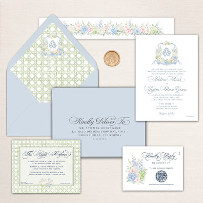 Elegant coastal wedding invitation suite with soft blue, sage green, ivory, blush pink, and hydrangea blue. The suite features a pale blue envelope with a watercolor green rattan-pattern liner and floral monogram crest, a coordinating gold monogram wax seal, and a formal white wedding invitation with delicate blue calligraphy and a watercolor floral crest. Coordinating pieces include an addressed envelope, a floral-lined belly band, a rattan-bordered reception card, and RSVP with QR code.