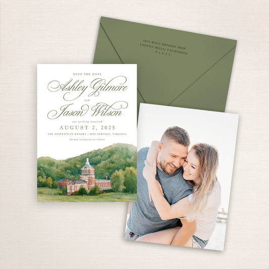 The Homestead Resort save the date featuring a hand-painted watercolor illustration of the historic red-brick resort nestled in the Virginia mountains, elegant sage script typography, coordinating green envelope, and engagement photo printed on the back.